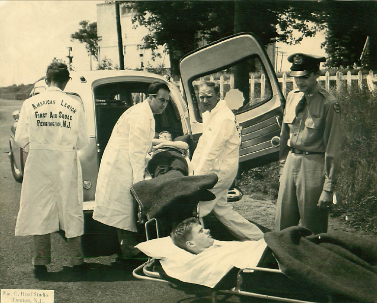 crew loading patients into Packard ambulance